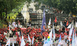 Workers  demonstrating against government employment regulation policies to mark May Day o...