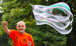 A man makes giant soap bubbles using a home made stuff in the Black sea town of Varna, Wed...