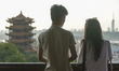 A couple admire a general view of Wuhan and Yellow Crane Tower situated on Sheshan (Snake...