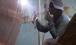 A Dock Yard laborer is working at the workshop for making parts of ship in Keranigonj, Dha...