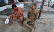 Wrestlers exercise at a traditional Indian wrestling training center on the banks of the r...