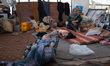 A Palestinian family takes refuge at a shelter in Gaza city center after losing their home...