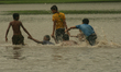 Indian Boys Play Football  Waterlogged Ground  after heavy Rainfall on June 20,2017 in Kol...