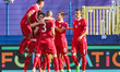 Mijat Gacinovic of Serbia celebrates with team mates after scoring his team's first goal d...