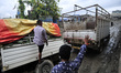 Workers arranging another vehicle to transfer the materials to pull out the vehicle trappe...