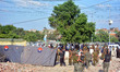 Security personnel inspect the blast site in eastern Pakistan's Lahore, on July 24, 2017....
