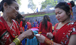 Nepalese devotees offering oil and butter lamps during Teej festival celebrations at Pashu...