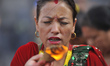 Nepalese devotees offering oil and butter lamps during Teej festival celebrations at Pashu...