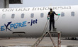  worker washing aircraft after repair workshop Garuda AeroAsia maintenance, maintenance an...
