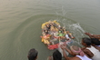 Indian labourers carrying the idol of Hindu goddess Durga for immersion on the banks of th...