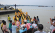 Indian labourers carrying the idol of Hindu goddess Durga for immersion on the banks of th...