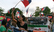 Protesters wave Philippine flags in front of the Office of the Ombudsman in Quezon City....