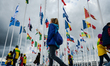 Participants are walking in front of the flags of the countries worldwide, during the Gran...