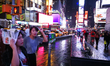 People walk in Times Square during a rainy day in New York, United States, on October 11,...