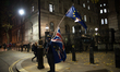 An anti-Brexit demonstrator waves the EU flag and the Union flag, outside Downing Street,...