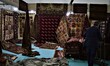 A man is seen in front of his stand at the 14th International Gifts and Handicrafts Fair i...