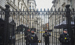 Police Officers are pictured outside the gates of Downing Street, London on December 6, 20...