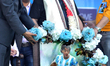 Former World Cup Argentine footballer Diego Maradona looks at his portrait during a visit...