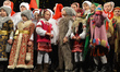 Local children dressed in costumes of traditional Folk Christmas Carolers perform during t...