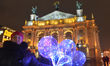 A lady holds balloons for sale near the Lviv Theatre of Opera and Ballet. On Friday, Janu...