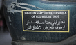 A bumper sticker warning drivers they will get shot when approaching is seen on a Lincoln...