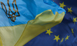 A view of EU and Ukrainian flags, coat of arms and symbols, seen in Lviv's city center. O...
