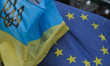 A view of EU and Ukrainian flags, coat of arms and symbols, seen in Lviv's city center. O...