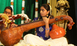 Tamil girl performs on the veena as Tamil youth perform traditional Carnatic songs during...