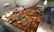 A staff of Krakow's well-known bakery 'Cichowscy' produces donuts for Fat Thursday. Fat Th...