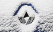 Snowflakes are seen on the badge of a Renault car in Warsaw, Poland February 8, 2018. 