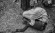 A Rohingya woman cries on the ground, as she received news, over the phone, that her husba...