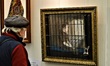 A visitor looks at an artwork on the second day of the ARTANKARA 4th Contemporary Art Fair...
