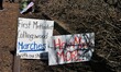Signs are left along trolly tracks that line Front streets after the March for Our Lives p...