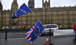 EU and Union Flags are waved opposit to the Houses of Parliament, London on March 27, 2018...