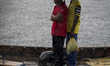 Bangladeshi commuters use boats to cross the Buriganga River  during rain in Dhaka, Bangla...