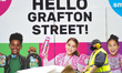 A street cleaner passes in front of 'Hello Grafton Street!' mural on Grafton Street in Dub...