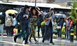 Young men walk during a heavy rainfall in the Sogutozu district of Ankara, Turkey on May 6...