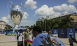 Real Madrid fans take a selfie in front of giant replica of the UEFA Champions League Cup...