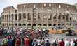 The pack of cyclists pedals past the ancient Colosseum during the last stage of the Giro d...