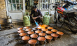 Worker burns cooper pots, Esfahan, Iran