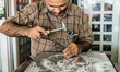 Artist embosses ghalamzani silver piece, ghalamzani means art of embossing patterns on dif...