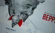 The twitter profile of Beppe Grillo is seen on a screen. 
