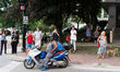 People along Belmont Avenue watch as a protest against gun violence passes by in Chicago o...