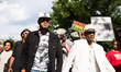Demonstrators march down Belmont Avenue towards Wrigley Field in a protest against gun vio...