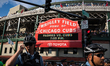 Rows of Chicago police officers surround the entrances of Wrigley Field, blocking demonstr...
