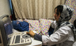 Dr. Rayhana Safi makes ultrasound scanning of woman in burka in Central Hospital of Afghan...