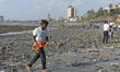 A volunteer removes an idol made of clay from a beach in Mumbai.  
