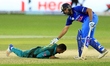 Indian cricket captain Rohit Sharma looks down at Pakistan's Mohammad Nawaz who falls down...