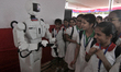 College students interact with humanoid robot ''INDRO'' during an exhibition of a college...
