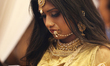 Indian fashion model checks her phone after modeling an elegant outfit during a South Asia...